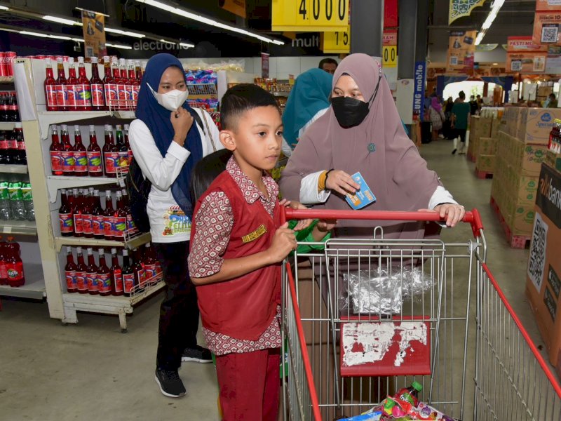 Ketua Tim Penggerak PKK Sulsel, Naoemi Octarina, membagikan kado lebaran bersama anak yatim dan kaum dhuafa. @Jejakfakta/dok. Pemprov Sulsel