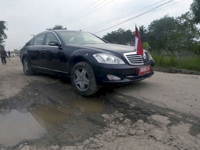 Mobil dinas Presiden Joko Widodo melintas di jalan rusak di Kampung Rama Nirwana, Seputih Raman, Lampung Tengah, Lampung, Jumat (5/5/2023). Presiden Jokowi mengucurkan dana Rp 800 miliar untuk memperbaiki jalan rusak di Provinsi Lampung.(ANTARA FOTO/ARDIANSYAH)