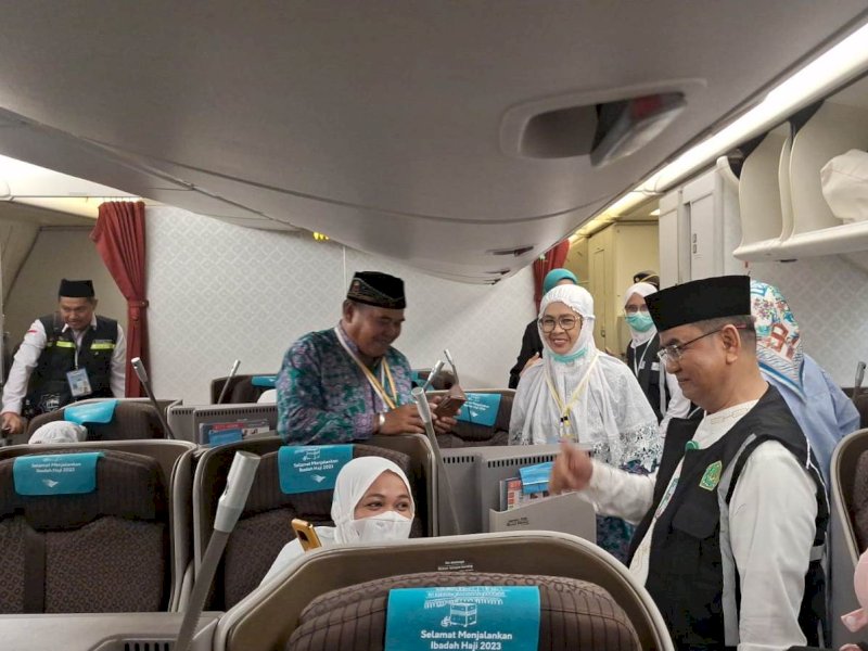 Khaeroni menyapa jemaah haji yang sudah berada di dalam Pesawat Garuda GIA 1102. @Jejakfakta/dok. Kemenag Sulsel