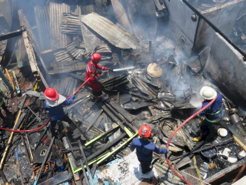 Sejumlah petugas dampak menyiram sisa puing yang masih terbakar saat terjadi kebakaran di di Jalan Barukang Utara, Kecamatan Ujung Tanah, Kota Makassar, Jum'at (8/9/2023). @Jejakfakta/Samsir