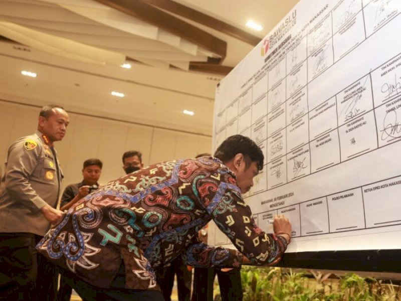 PJ Sekda Kota Makassar, Firman Hamid Pagarra menandatangani komitmen bersama forkopimda Kota Makassar dalam rangka mewujudkan pemilu 2024 yang sejuk, aman dan damai. @Jejakfakta/dok. Humas Pemkot Makassar