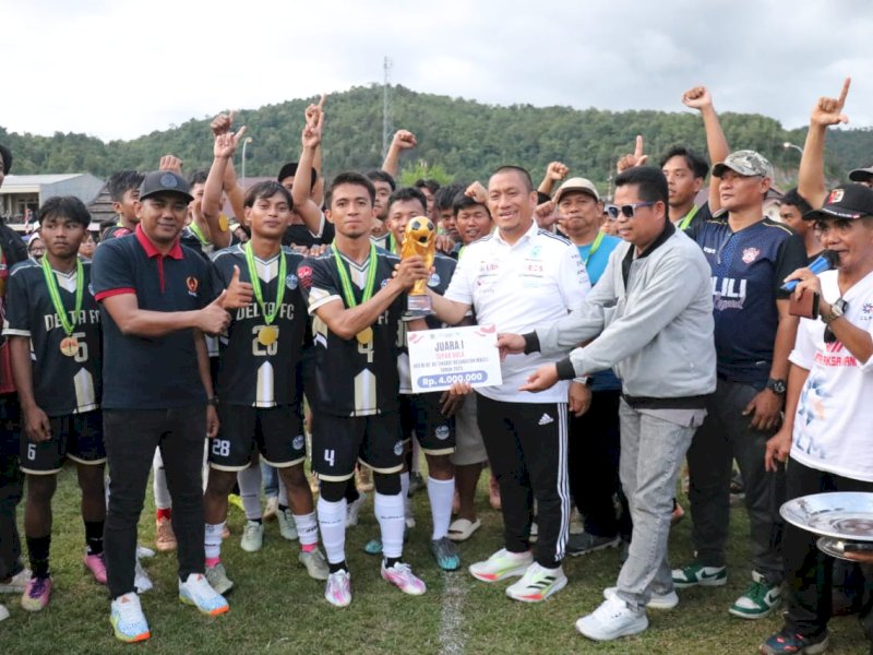 Bupati Luwu Timur, Irwan Bachri Syam, menyerahkan piala kepada Lakawali Pantai FC Juara Turnamen HUT ke-80 RI di Balantang, di Lapangan Birawa, Desa Balantang, Senin (18/08/2025). @Jejakfakta/dok. Humas Pemkab Lutim