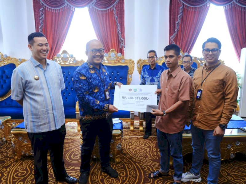 Penyerahan ganti rugi dan penandatanganan AJB dilakukan langsung oleh Bupati Pangkep, Muhammad Yusran Lalogau, bersama Kepala Balai Pengelolaan Kereta Api Sulawesi Selatan, Deby Hospital, Kepala Dinas Perhubungan, notaris, serta para penerima hak di Aula Rumah Jabatan Bupati Pangkep, Kamis, (26/2/2026). @jejakfaktacom/Humas Pemda Pangkep
